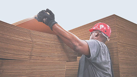 Photo of Greif worker stacking cardboard boxes